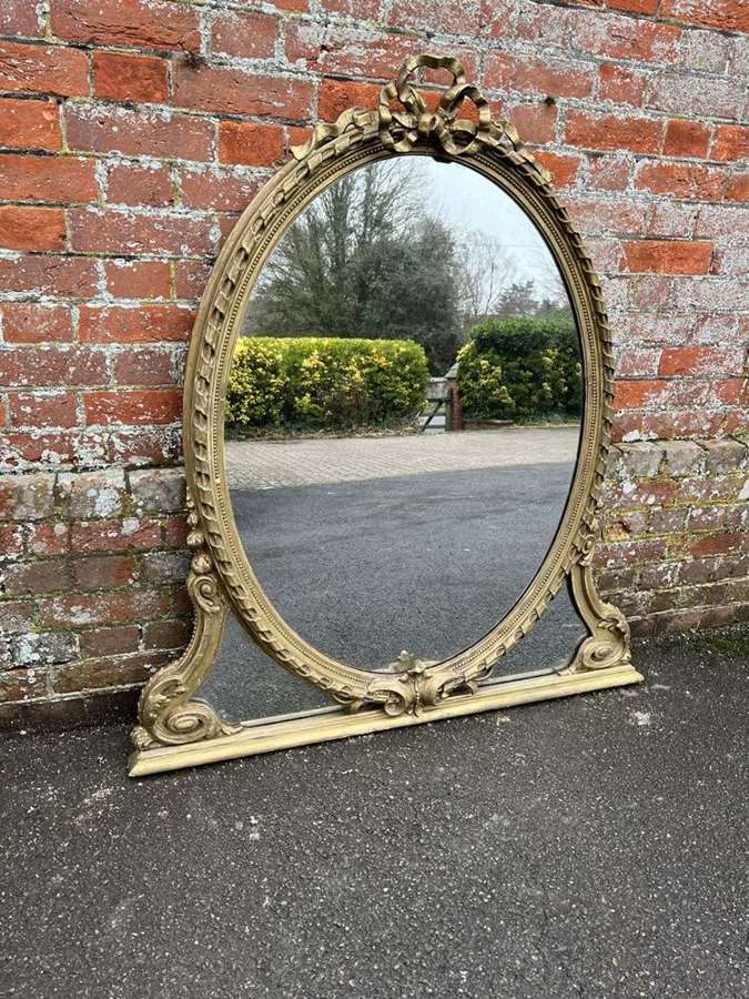 A Delightful Antique English 19th Century gilt Oval Overmantle Mirror.