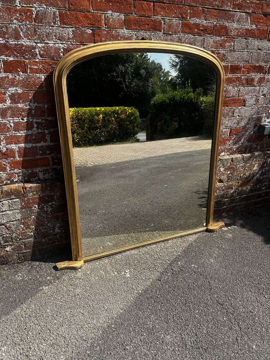 A Delightful large Antique English 19th C arched top gilt Mirror.