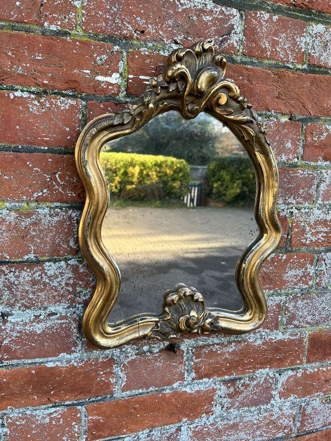 A Delightful useful size Antique 19th C French gilt shaped Mirror.