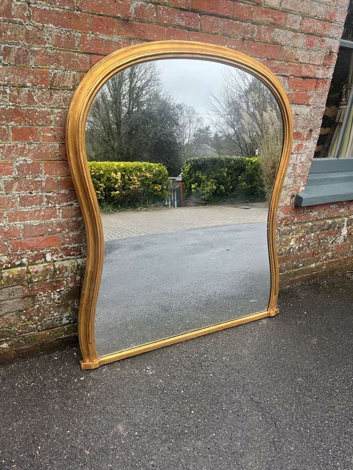 An Exceptional large Antique English 19th C shaped gilt carved Mirror.