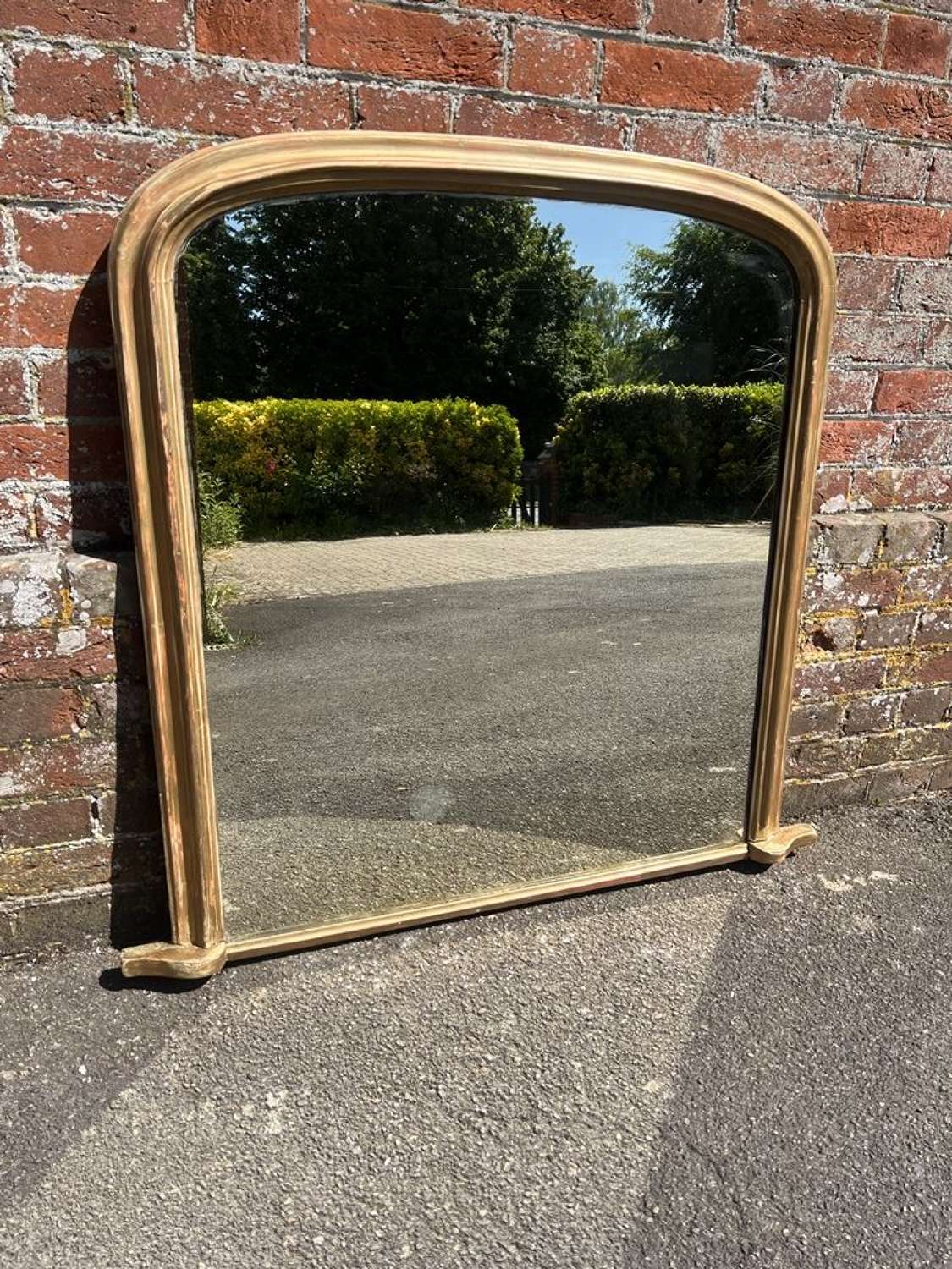 A Delightful Antique English 19th C arched top gilt Overmantle Mirror.