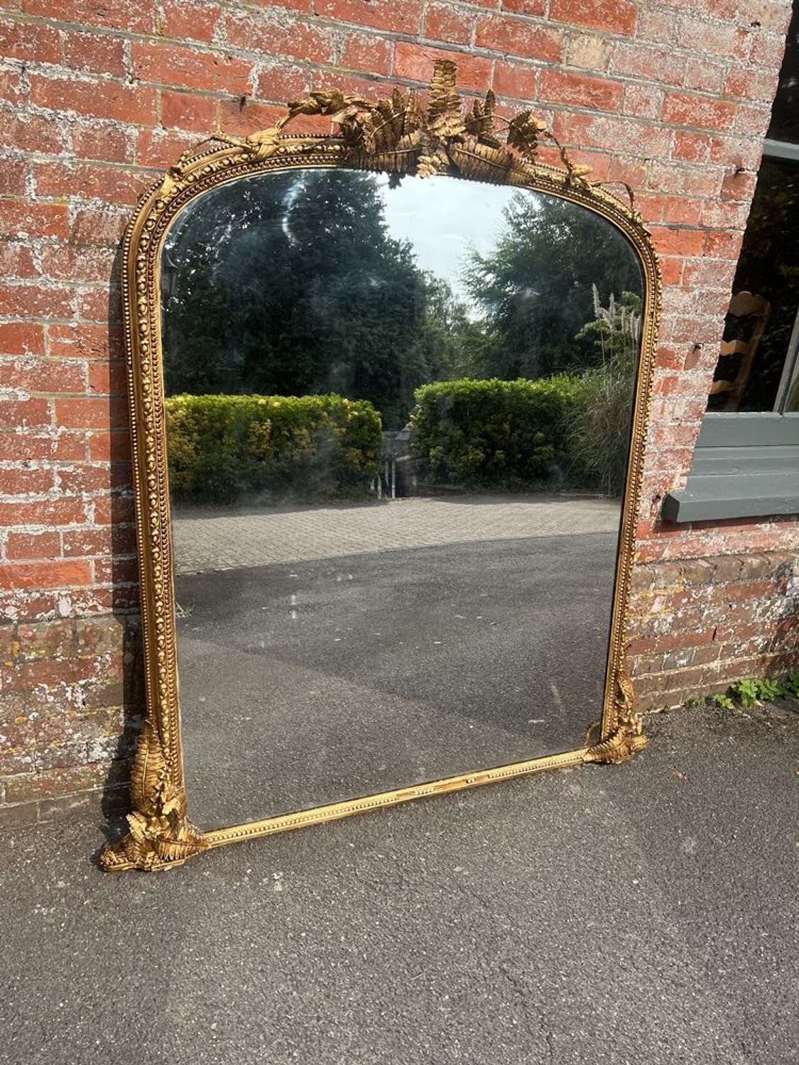 An Exceptional large Antique English 19th C arched gilt Mirror.