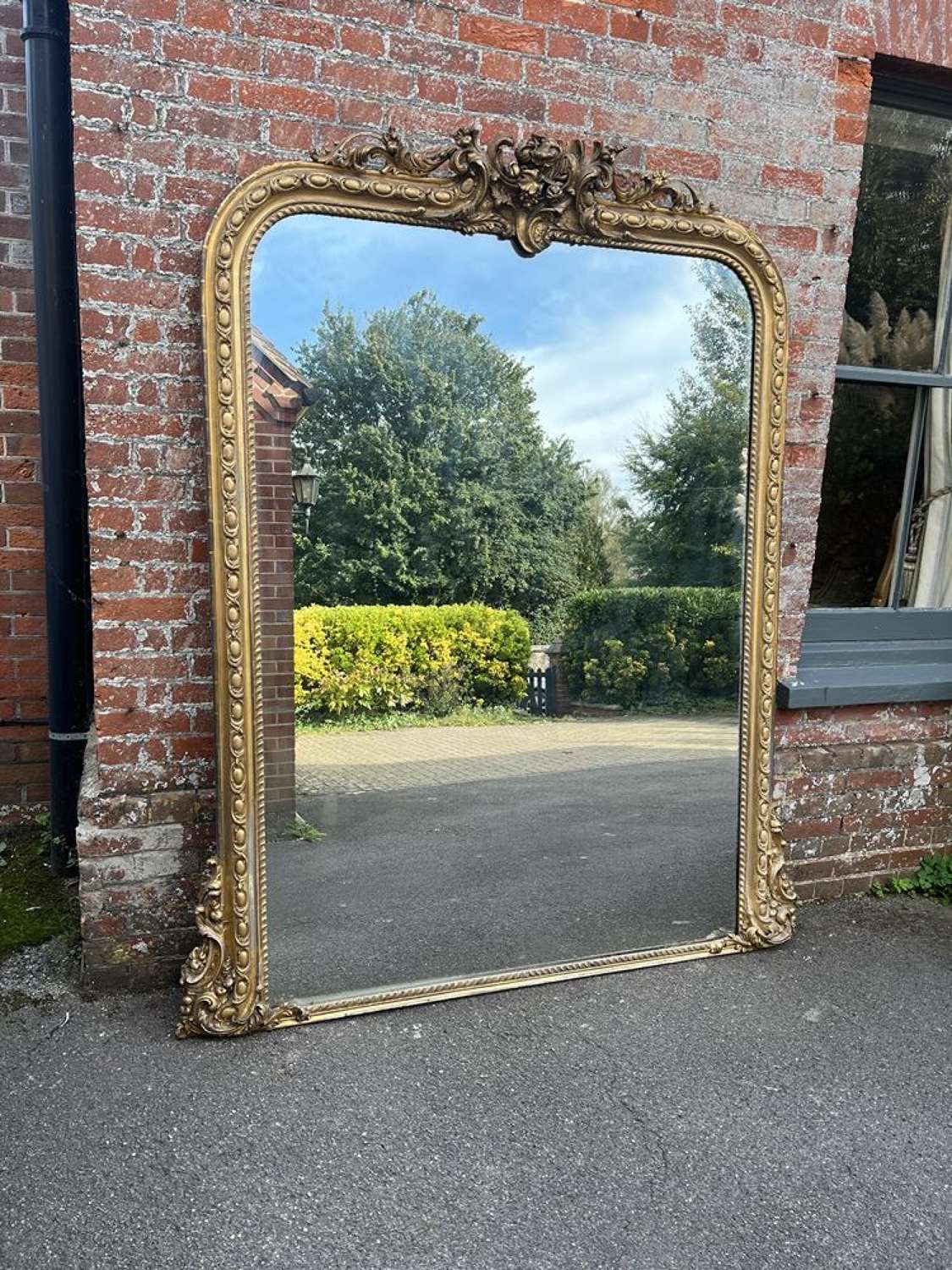 A Spectacular large Antique English 19th C arched top Gilt Mirror.