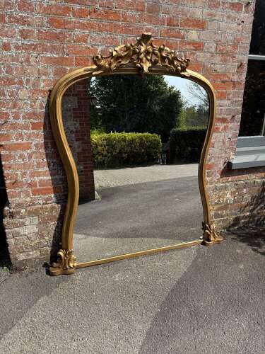 A Spectacular large Antique English 19th C shaped gilt Overmantle Mirror.
