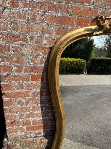 A Spectacular large Antique English 19th C shaped gilt Overmantle Mirror.