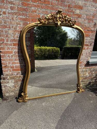 A Spectacular large Antique English 19th C shaped gilt Overmantle Mirror.
