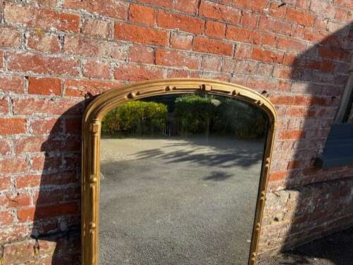 A Delightful large Antique Large English 19th C arched top gilt Overmantle Mirror.