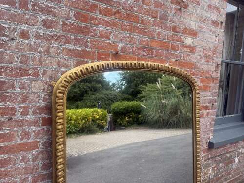 A Spectacular large Antique English 19th C arched top gilt ribbed framed Oermantle Mirror.
