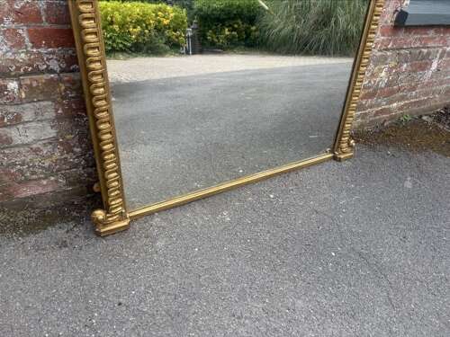 A Spectacular large Antique English 19th C arched top gilt ribbed framed Oermantle Mirror.