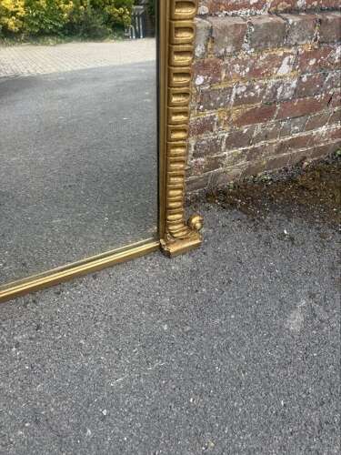 A Spectacular large Antique English 19th C arched top gilt ribbed framed Oermantle Mirror.