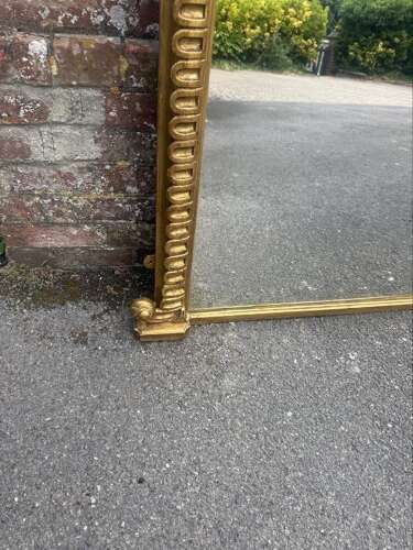 A Spectacular large Antique English 19th C arched top gilt ribbed framed Oermantle Mirror.