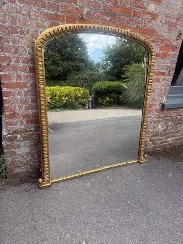 A Spectacular large Antique English 19th C arched top gilt ribbed framed Oermantle Mirror.